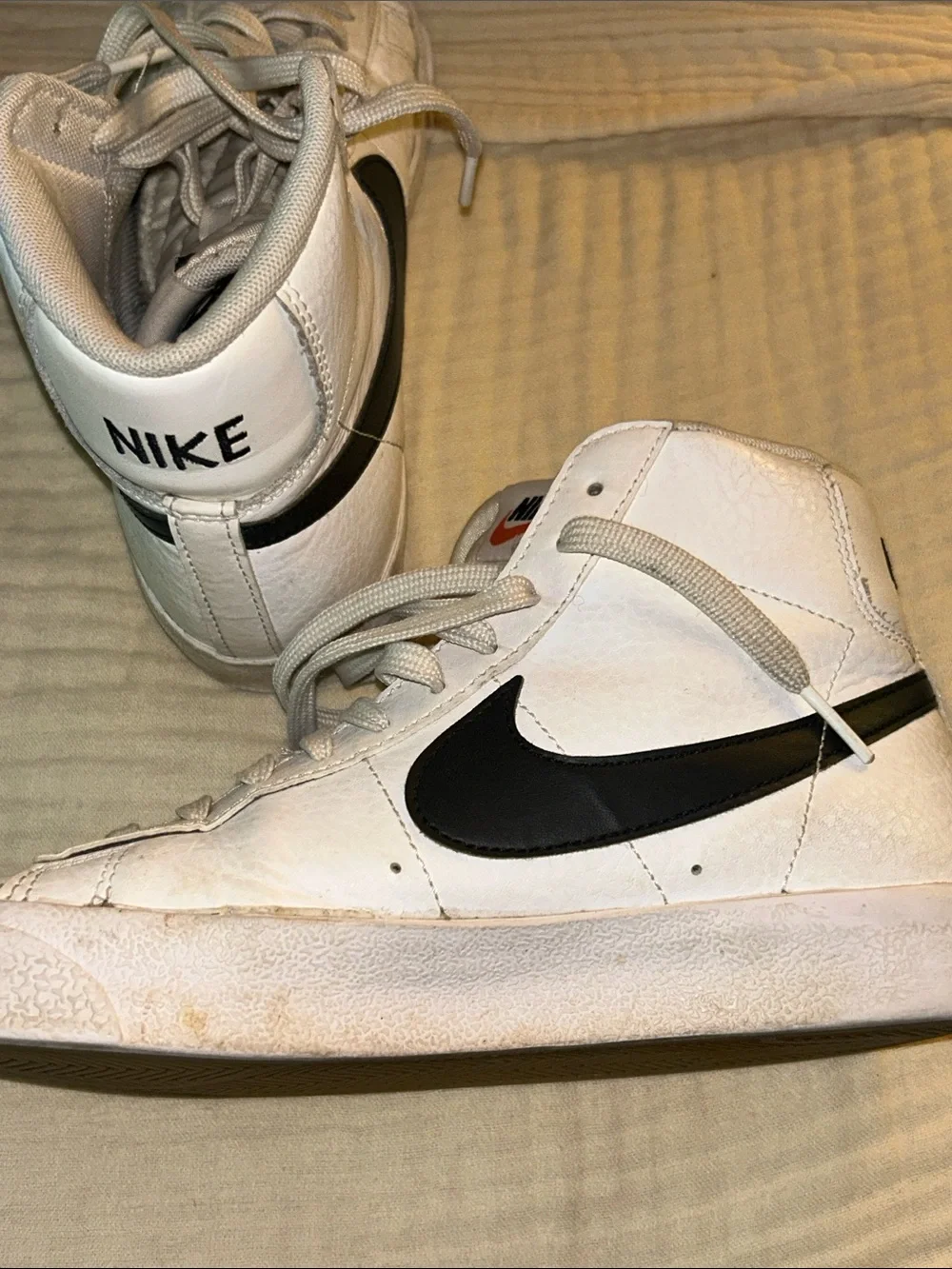 Nike White High-Top Sneakers with Black Swoosh